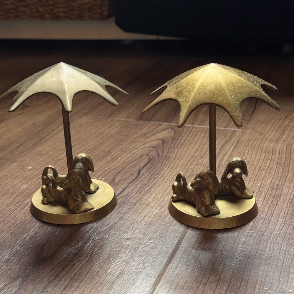 A pair of brass Dachshunds under umbrella figurines
